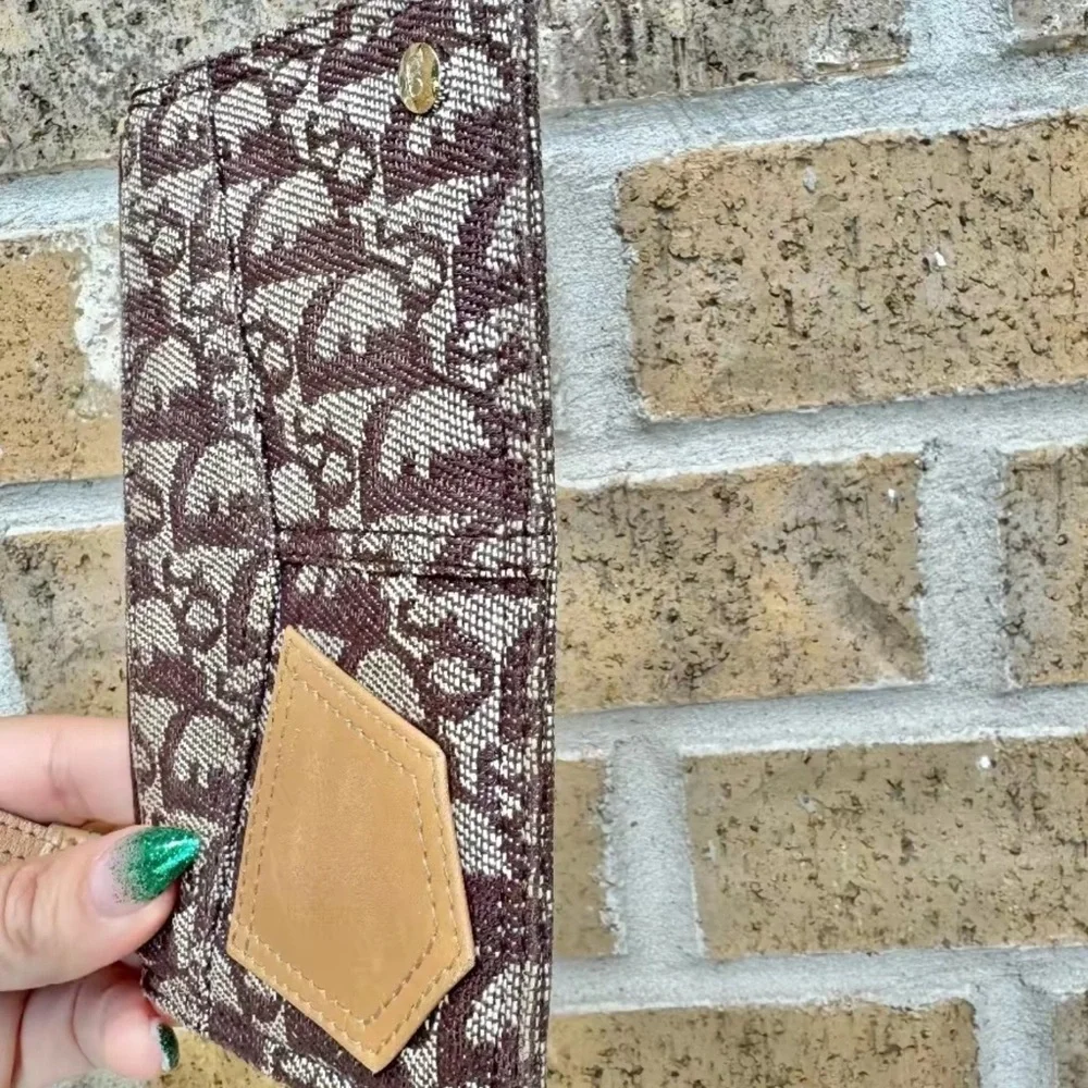 Christian Dior monogram wristlet. Comes with copy of COA from Entrupy